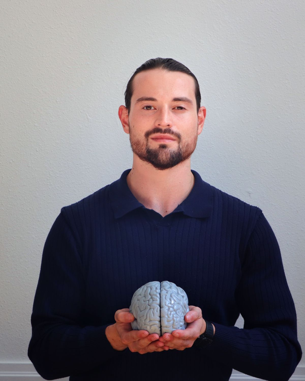 Anthony Sosa holding a model of the human brain